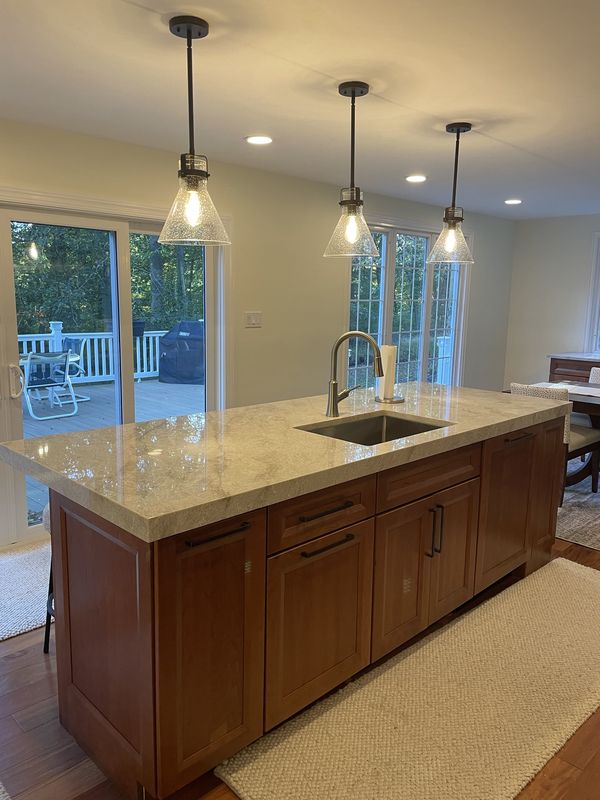 After: the finished kitchen, with the same sliders behind the island