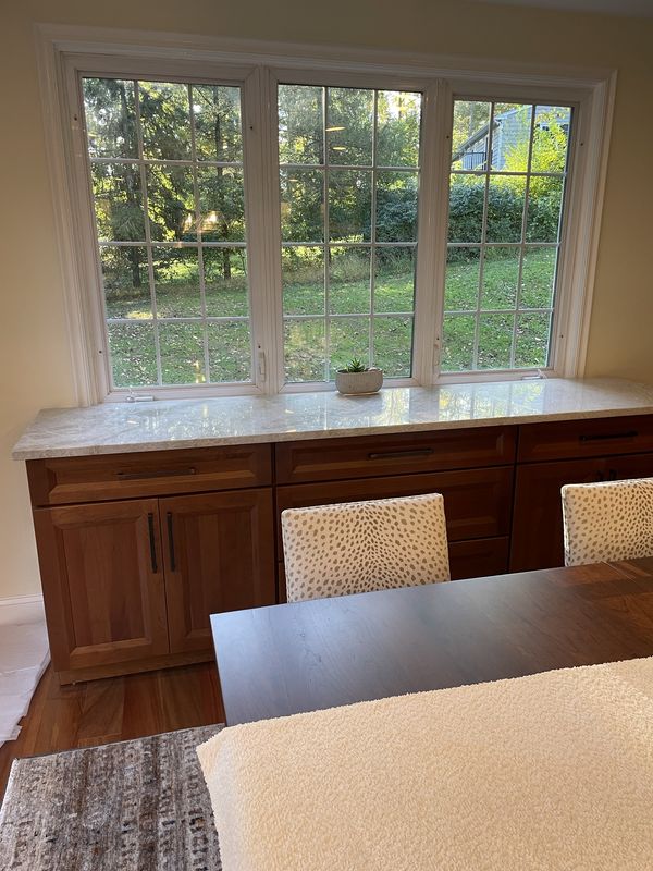 Matching wood built-in buffet under the dining-room windows